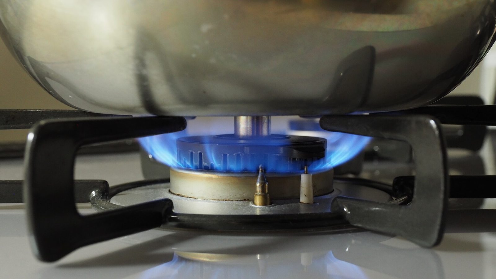 A lit burner on a gas stove
