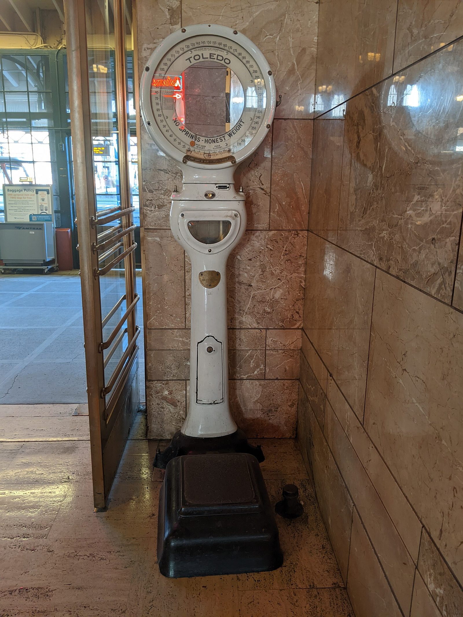 A vintage coin-operated weighing scale