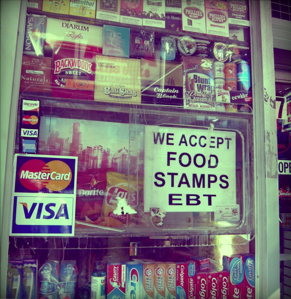 A deli window sign: "We Accept Food Stamps, EBT"